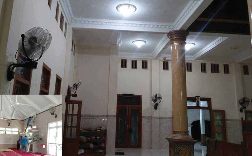Ruang dalam masjid dengan beberapa kipas angin berdiri dan kipas dinding